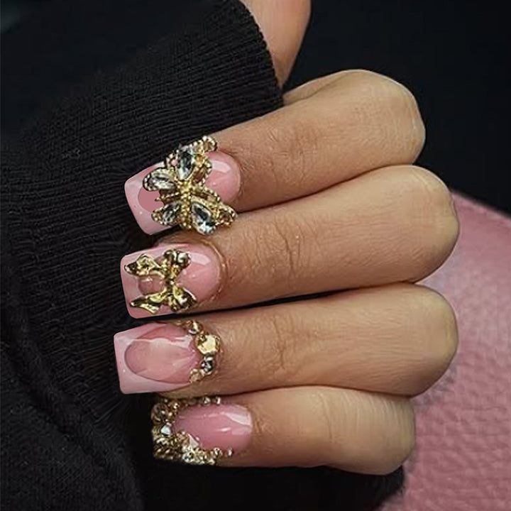 Glamorous artificial nail set with floral accents and glitter decorations Stornfield