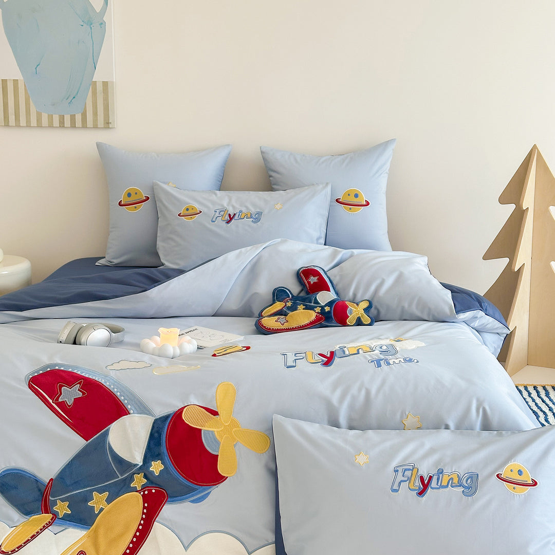 Children's bedding set with embroidered comic design and striped details