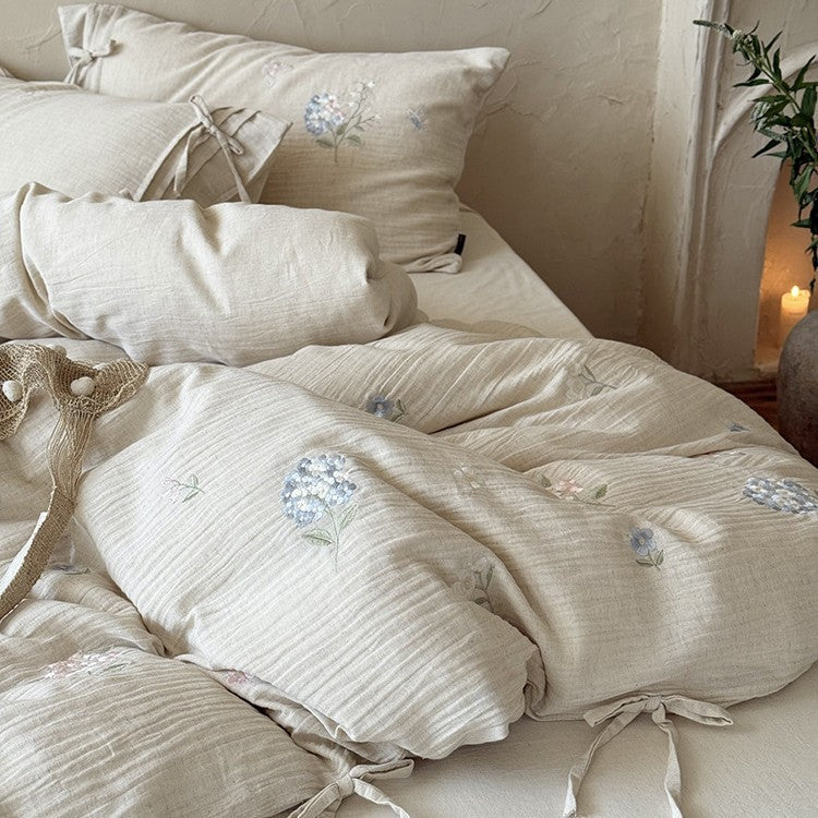 Embroidered cotton-linen bedding set with decorative ribbons and fine floral design