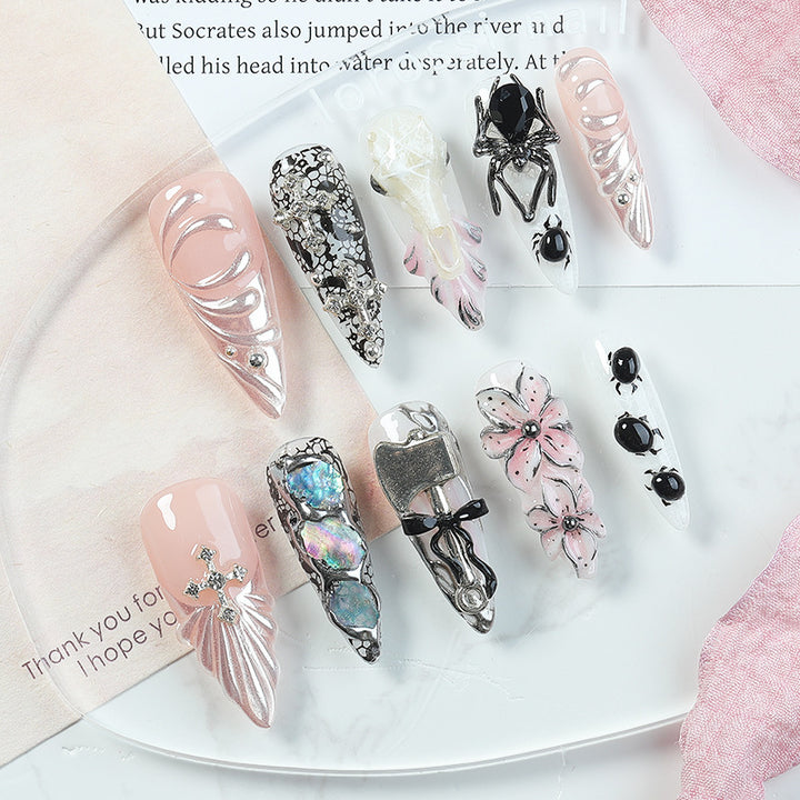Creative nail art set with Halloween motifs and intricate details Stornfield