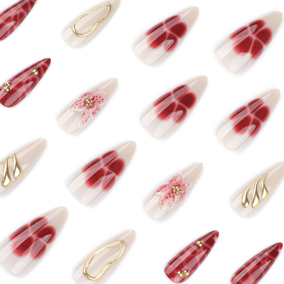 Artful stiletto nails with elegant floral designs and glitter accents Stornfield
