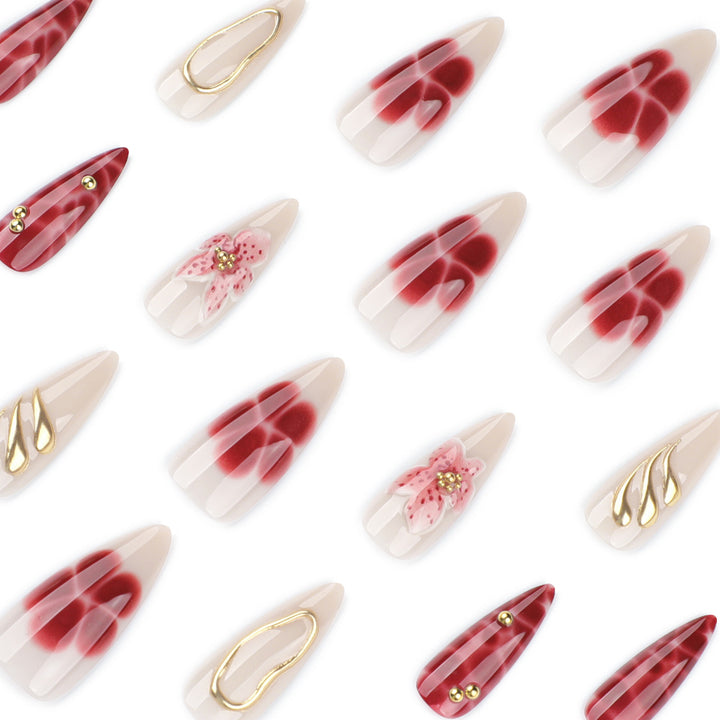 Artful stiletto nails with elegant floral designs and glitter accents Stornfield