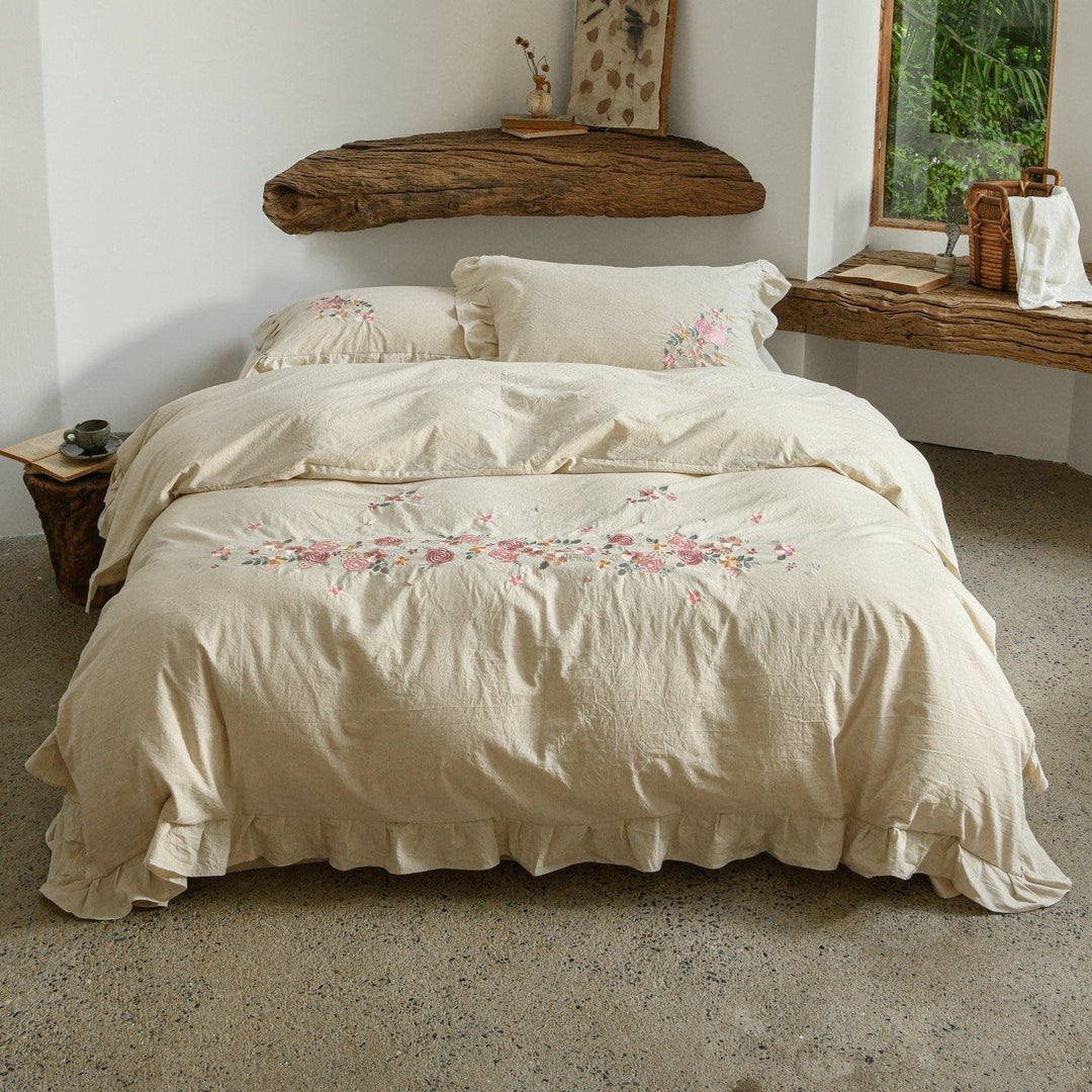 Embroidered linen-look bedding set with ruffle and floral embroidery detail