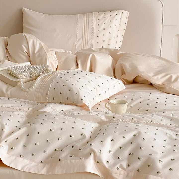 Exclusive satin bedding set with all-over rosebud embroidery and pleating details