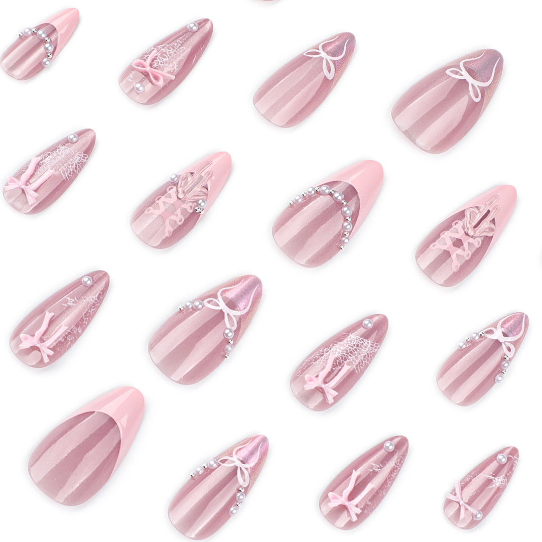 Artful nail extensions with delicate bow motifs Stornfield