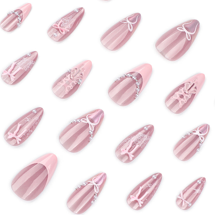Artful nail extensions with delicate bow motifs Stornfield