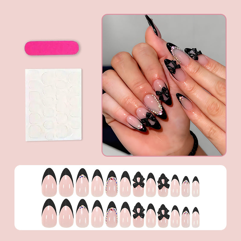 Artificial nail set with glamorous bow design and sparkling accents Stornfield