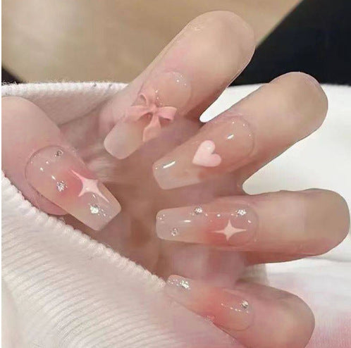 Artistic Nail Art with Glitter and Flower Applications Stornfield