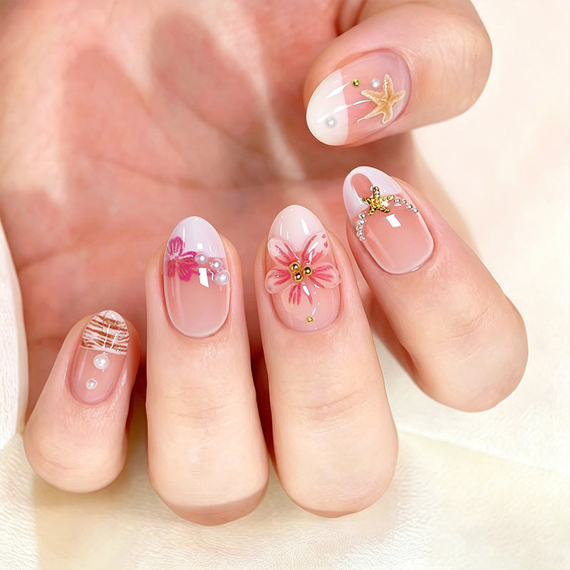 Elegant artificial nails with floral designs and glitter accents Stornfield