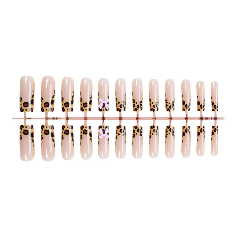 Decorative Stiletto Press-On Nail Art with Animal Print and Bow Accents Stornfield