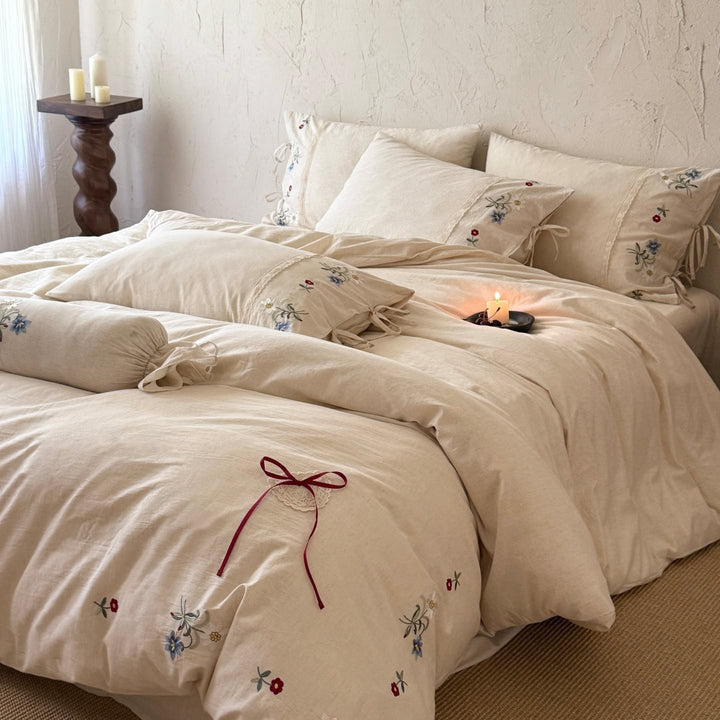 Bedding set made of linen look with floral embroidery and bow closure
