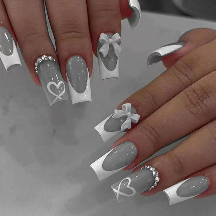 Artificial nail set with elegant bow and glitter decorations Stornfield