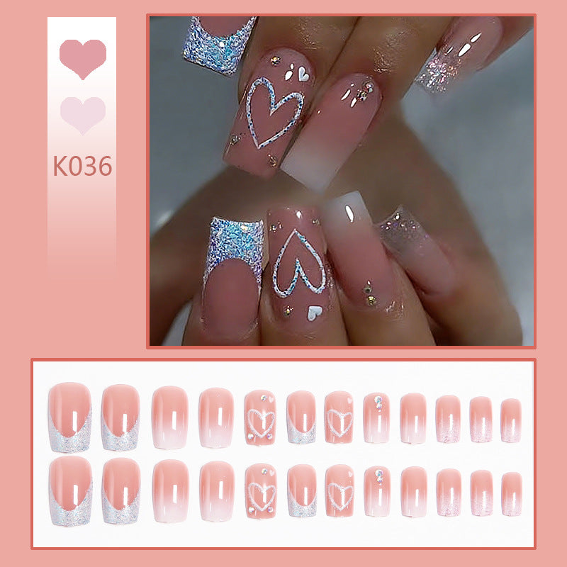 Artificial nails with sparkling heart designs and glitter details Stornfield