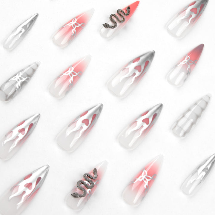 Artistic stiletto nails with snake motif Stornfield