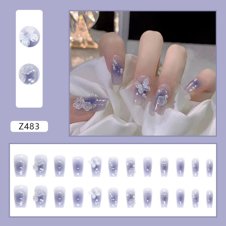 Artistic acrylic nails with butterfly design and glitter accents Stornfield