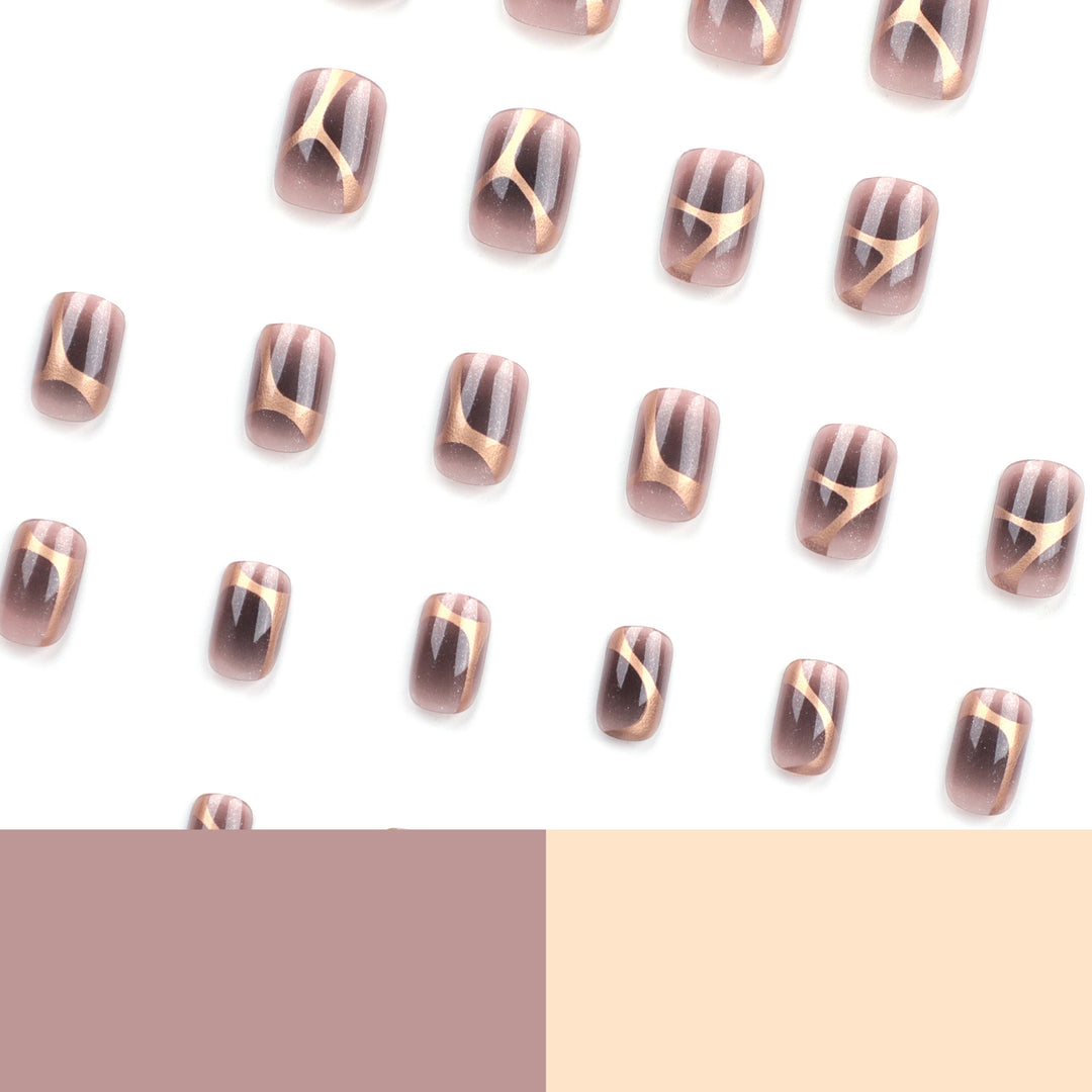 Artificial nail art with elegant metallic design and glitter accents Stornfield