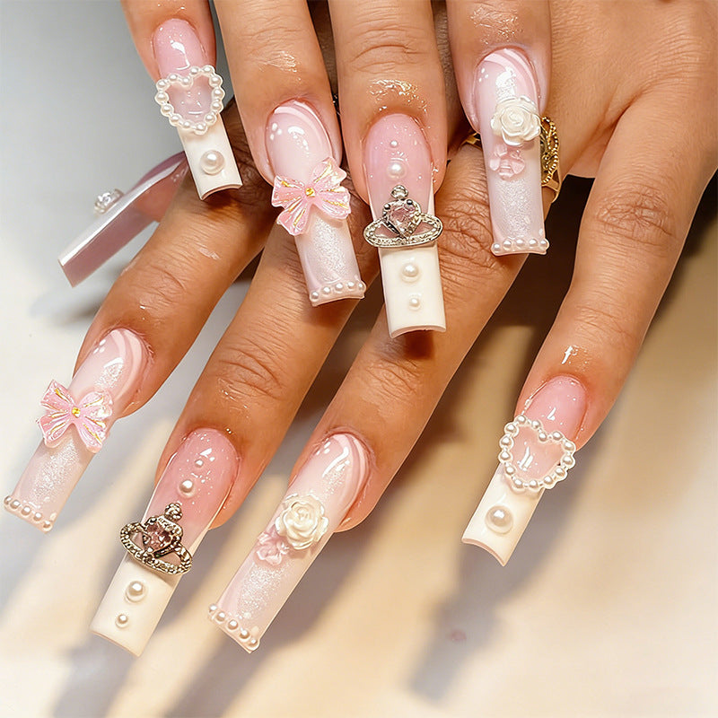 Artful nail tips with pearl and bow motifs Stornfield