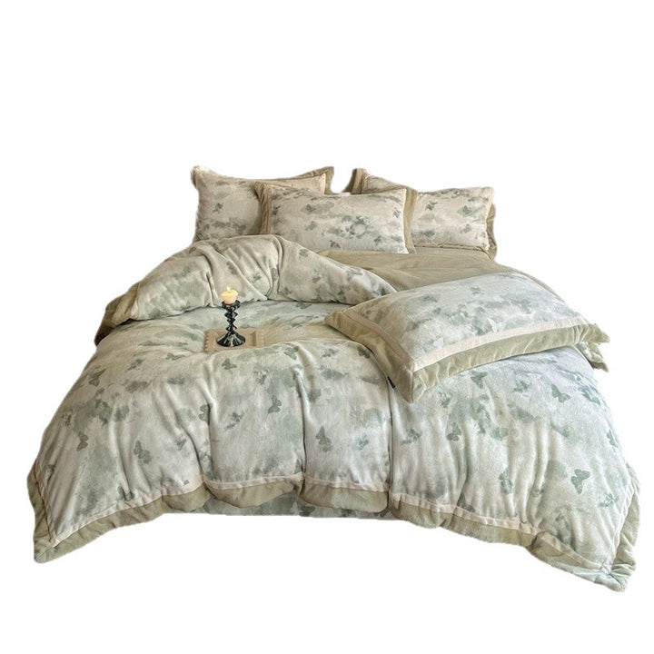 Luxurious quilted bedding set with velvet trim and floral branch motif