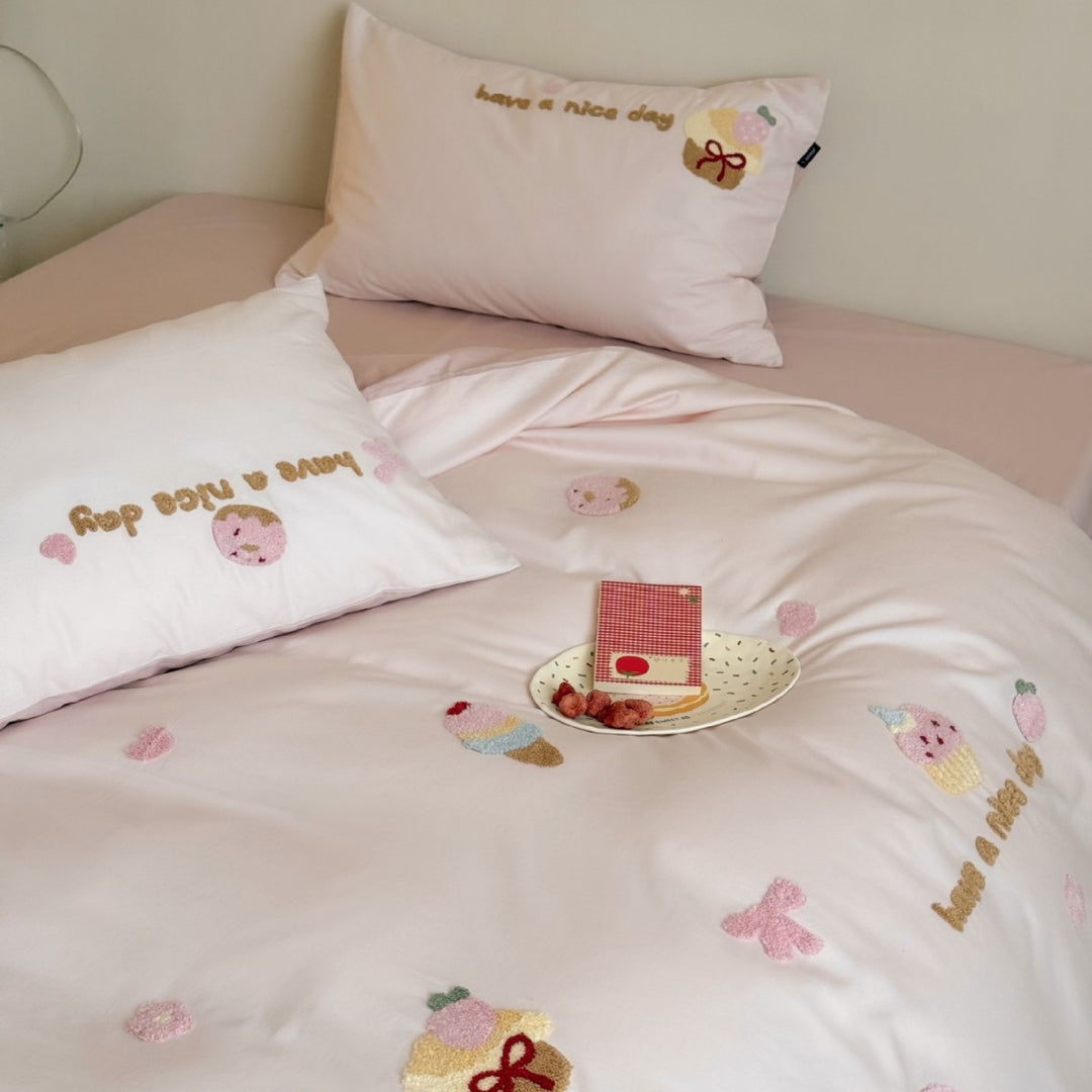 Quilted bedding set with cupcake embroideries and text application