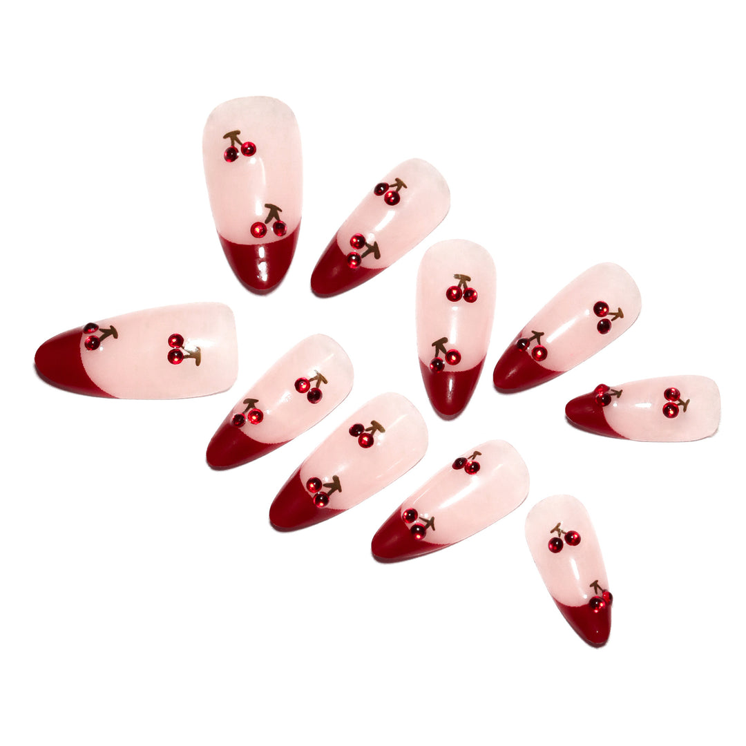 Artful stiletto nails with cherry motifs and glitter accents Stornfield