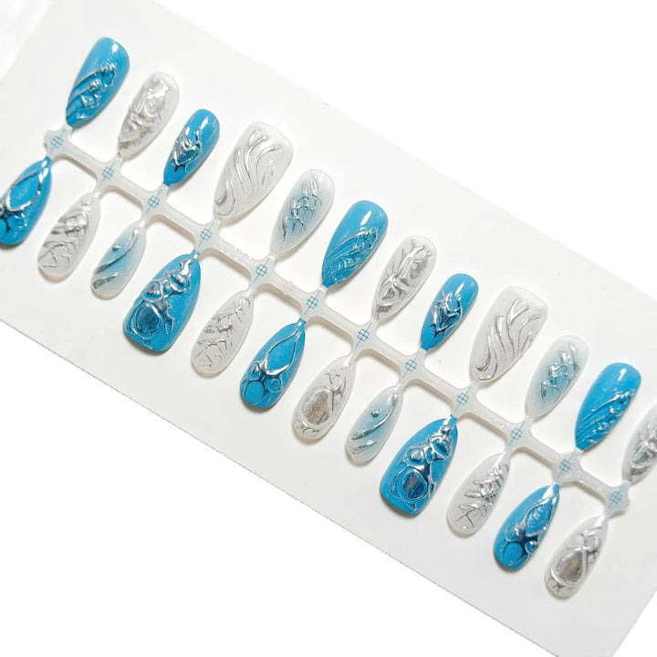 Creative artificial nails with shiny silver and turquoise tones Stornfield