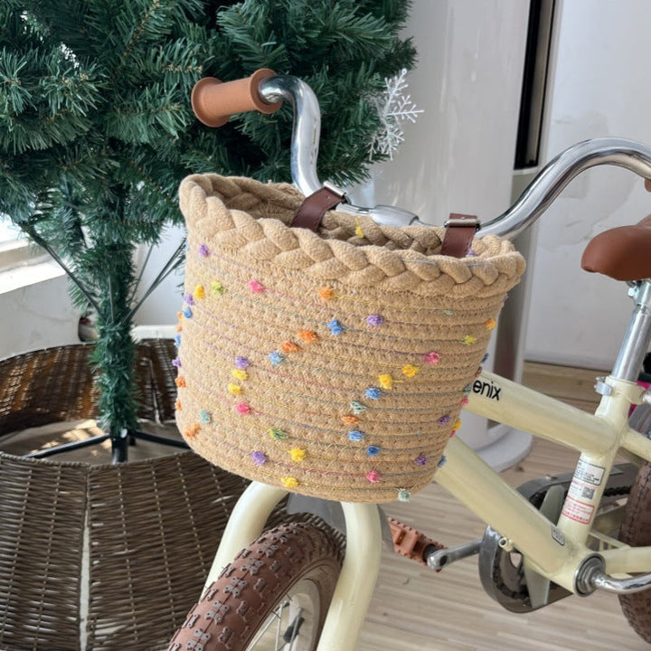 braided rope bike basket with pom pom embellishments and leather handlebar straps Stornfield