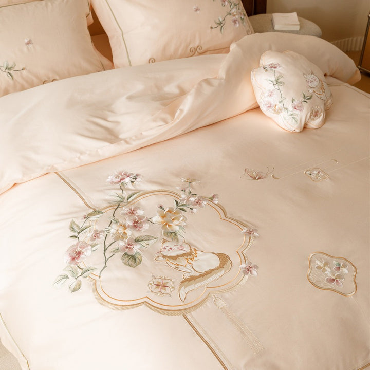 Luxurious cotton satin bedding set with fine embroidery, floral motifs, and decorative pillows