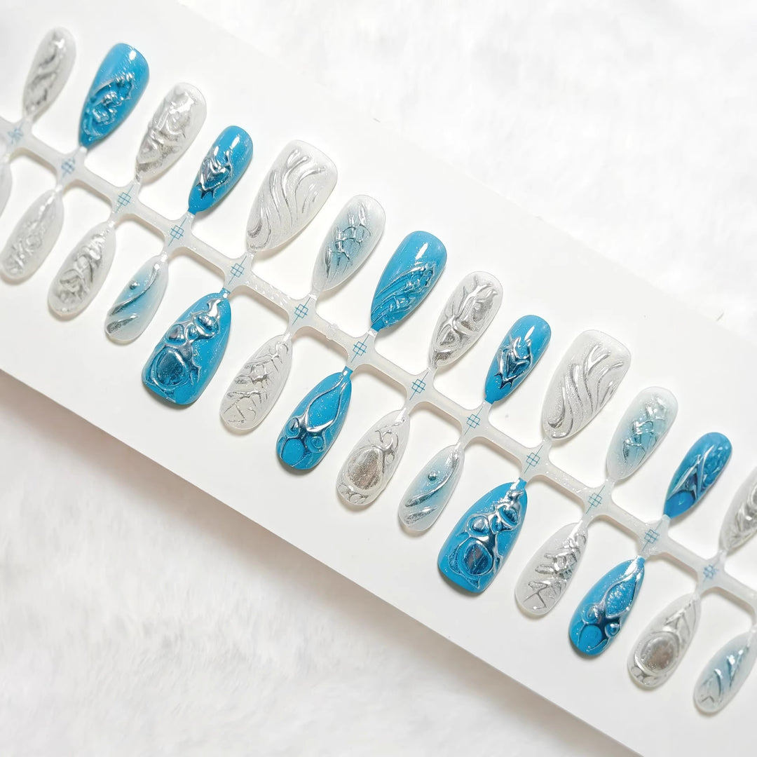 Creative artificial nails with shiny silver and turquoise tones Stornfield