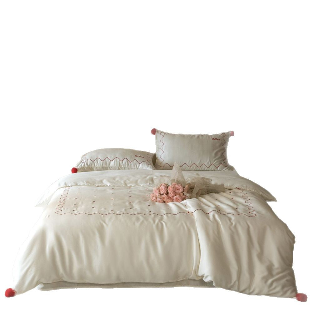Bedding set made of cotton satin with wavy embroidery edge and pompom cushion