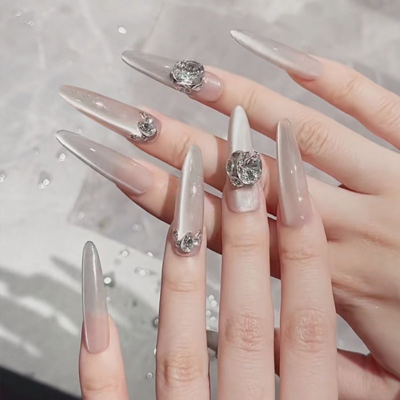 Acrylic nail set with elegant tips and glamorous rhinestone accents Stornfield