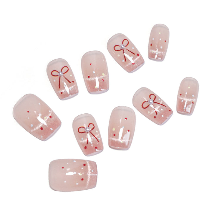 Artificial nail art with elegant bows and glitter accents Stornfield