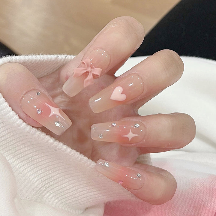 Artificial nails with heart and glitter accents Stornfield