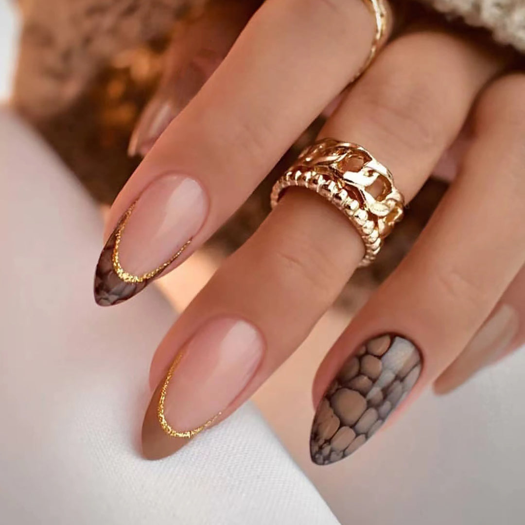 Artful stiletto nails with elegant gold decoration Stornfield