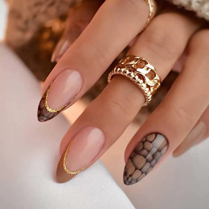 Artful stiletto nails with elegant gold decoration Stornfield