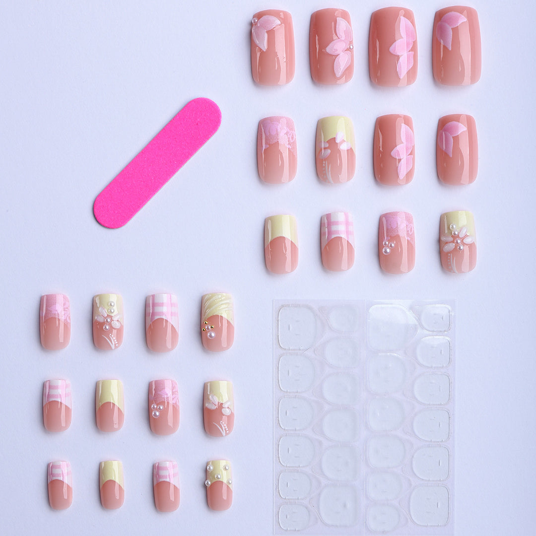 Artificial nails with creative floral designs and glitter accents Stornfield