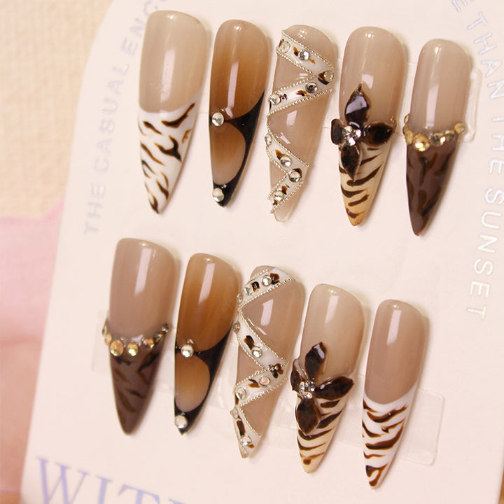 Artificial nails with extravagant designs and glitter accents Stornfield