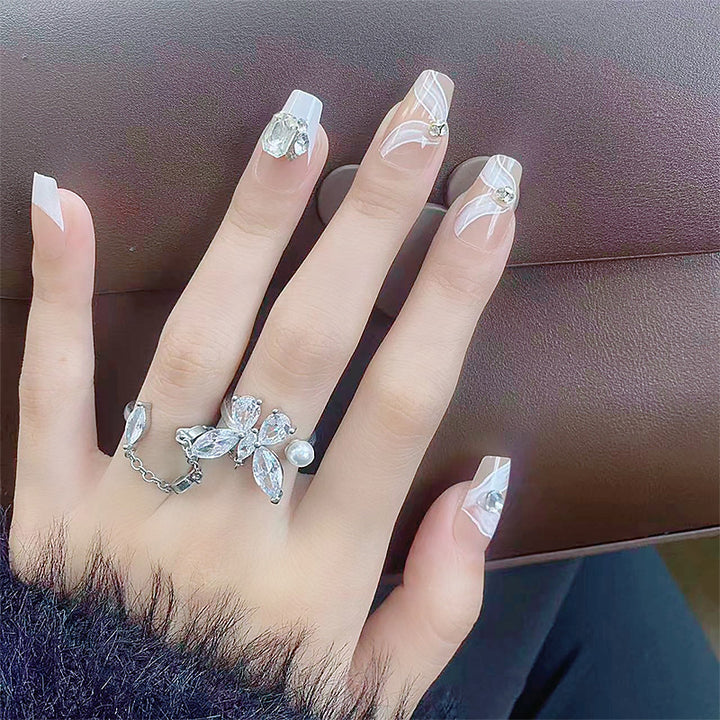 Elegant artificial nail set with delicate decorations and glitter elements Stornfield