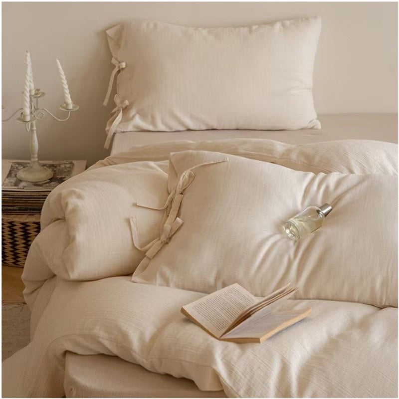 Reversible bed cover with decorative bows and light quilting