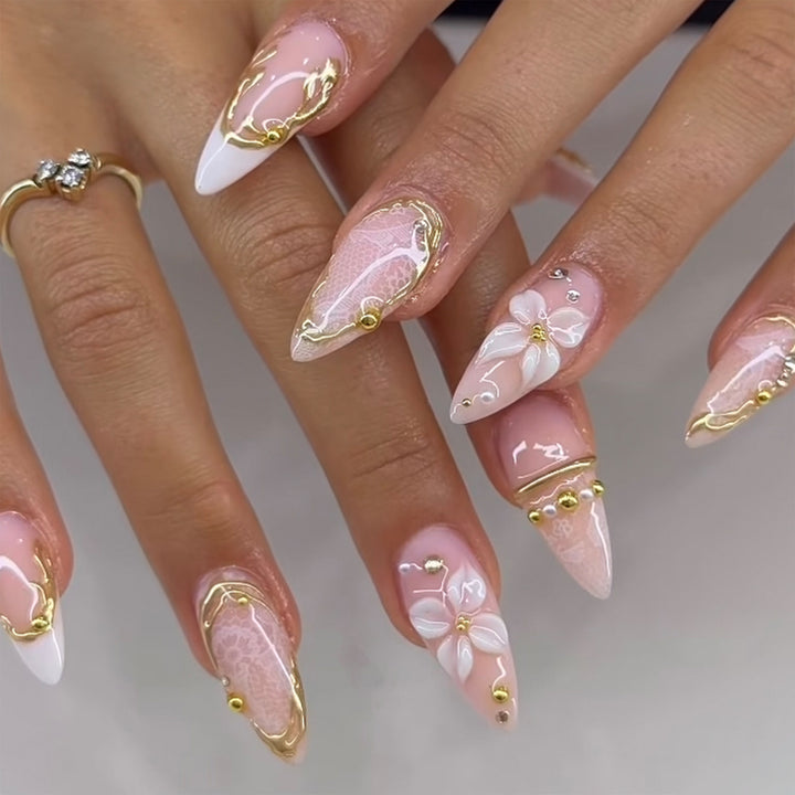 Artful nail extensions with delicate flower and gold embellishments Stornfield