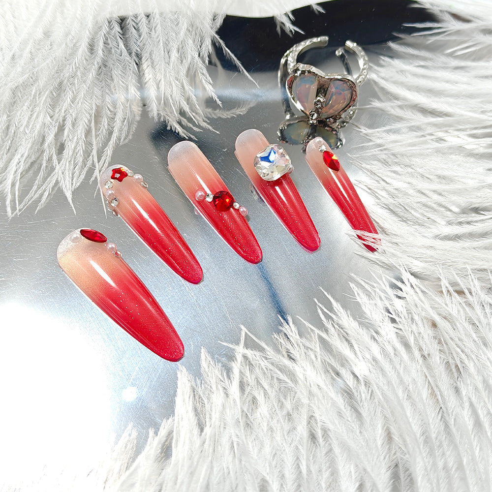 Artificial nails in elegant ombre style with glitter and jewelry accents Stornfield