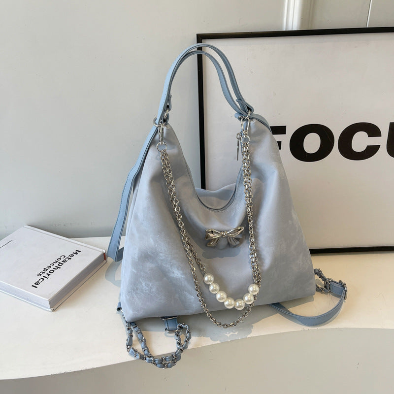 Fashionable handbag with unique pendant and chain accents Stornfield