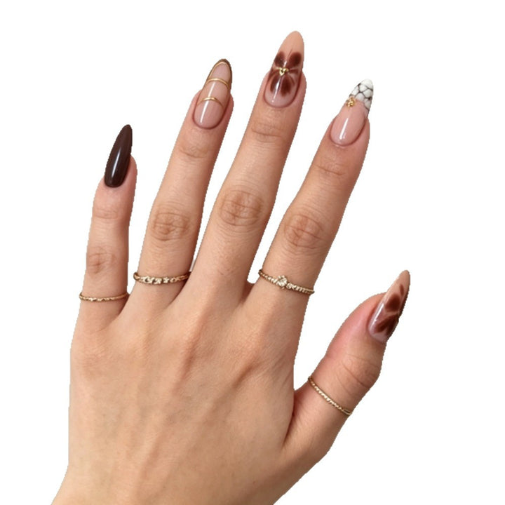 Artificial nails with elegant marble pattern and delicate accents Stornfield