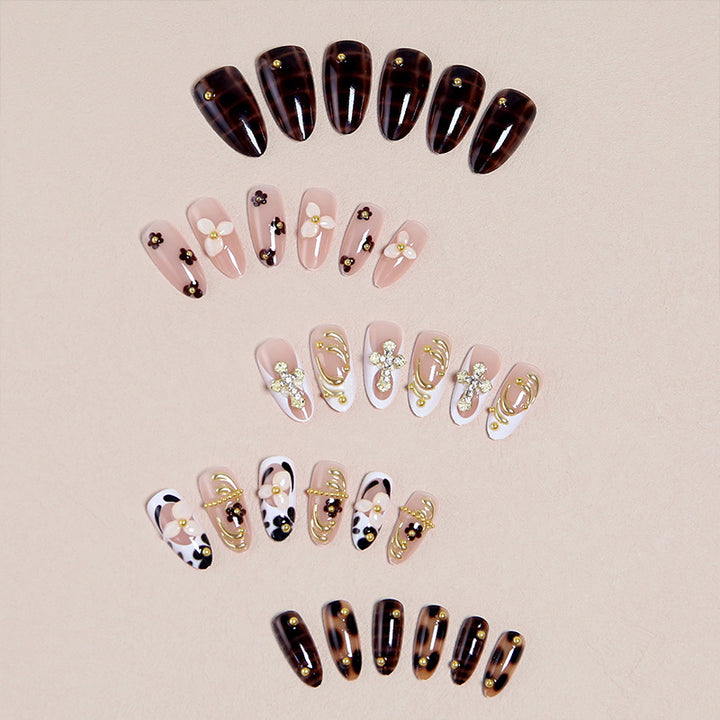 Artificial nails set with elegant gold accents and floral embellishments Stornfield