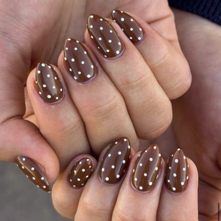 Artificial nail art with playful dots and bows Stornfield