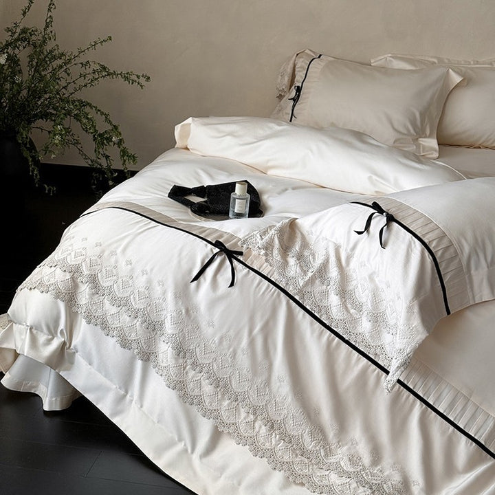 Fine cotton satin bedding set with lace ruffle, contrasting decorative ribbons and hotel closure