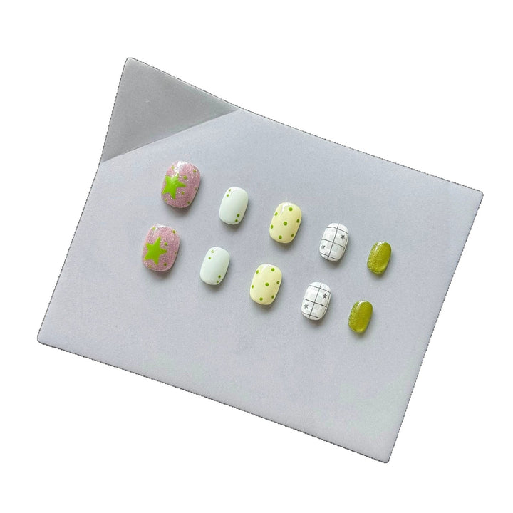 Playful Press-On Nail Art Set with Fun Patterns and Glitter Accents