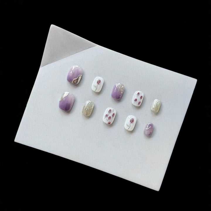 Artistic Press-On Nail Art Set with Floral and Metallic Accents