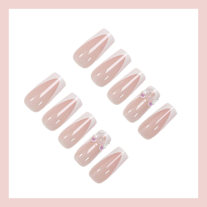 Artificial nail set with luxurious French tips and elegant jewelry embellishments Stornfield