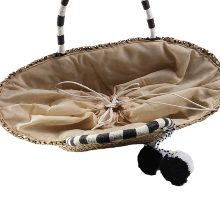 Braided beach bag with decorative pompons Stornfield