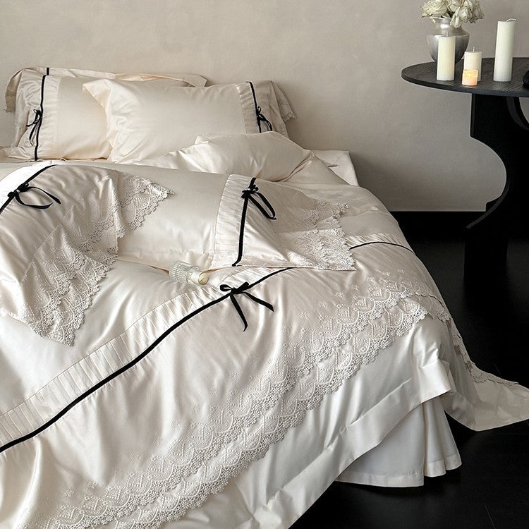 Fine cotton satin bedding set with lace ruffle, contrasting decorative ribbons and hotel closure